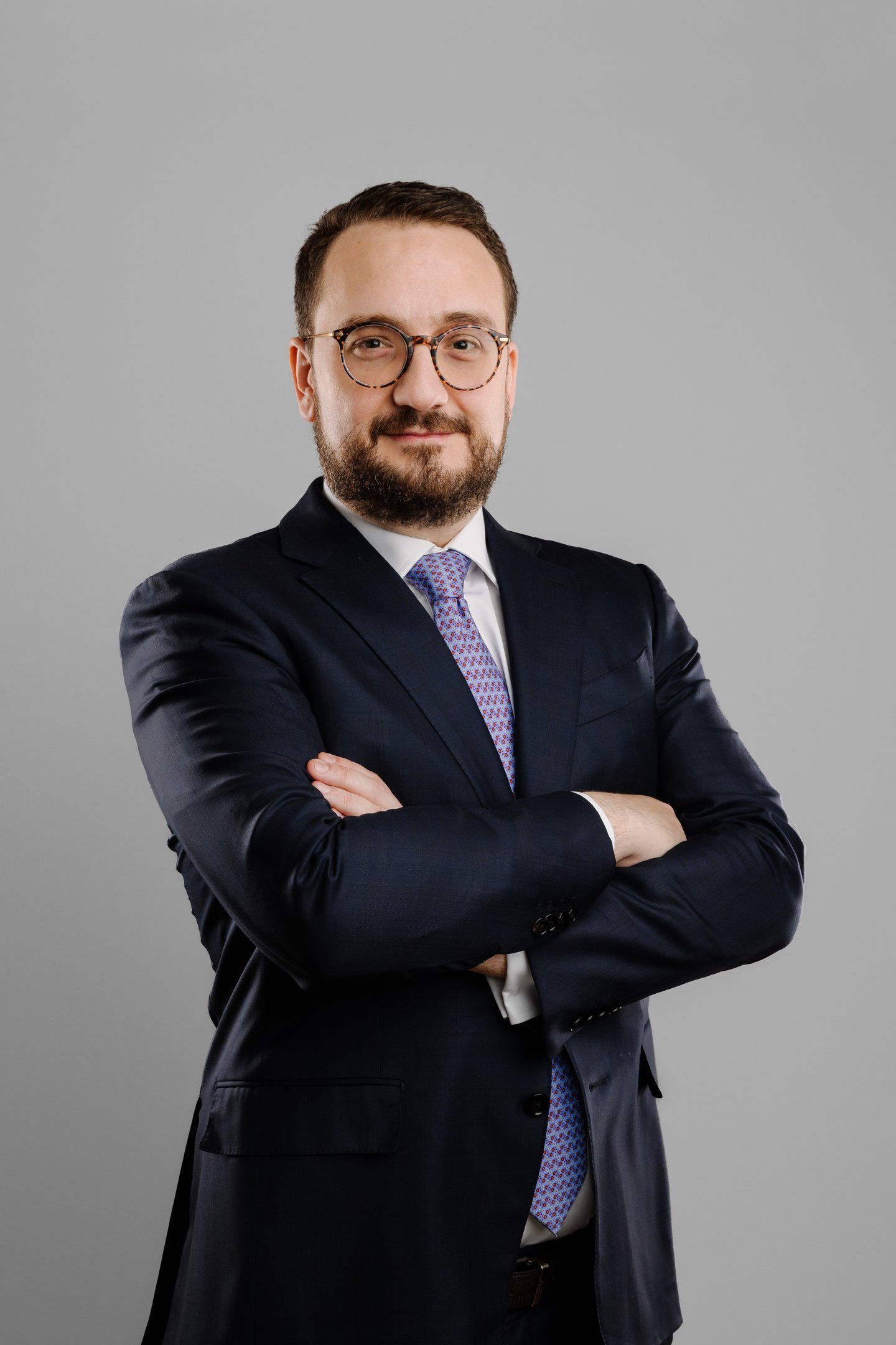 a man in a suit and tie with a beard